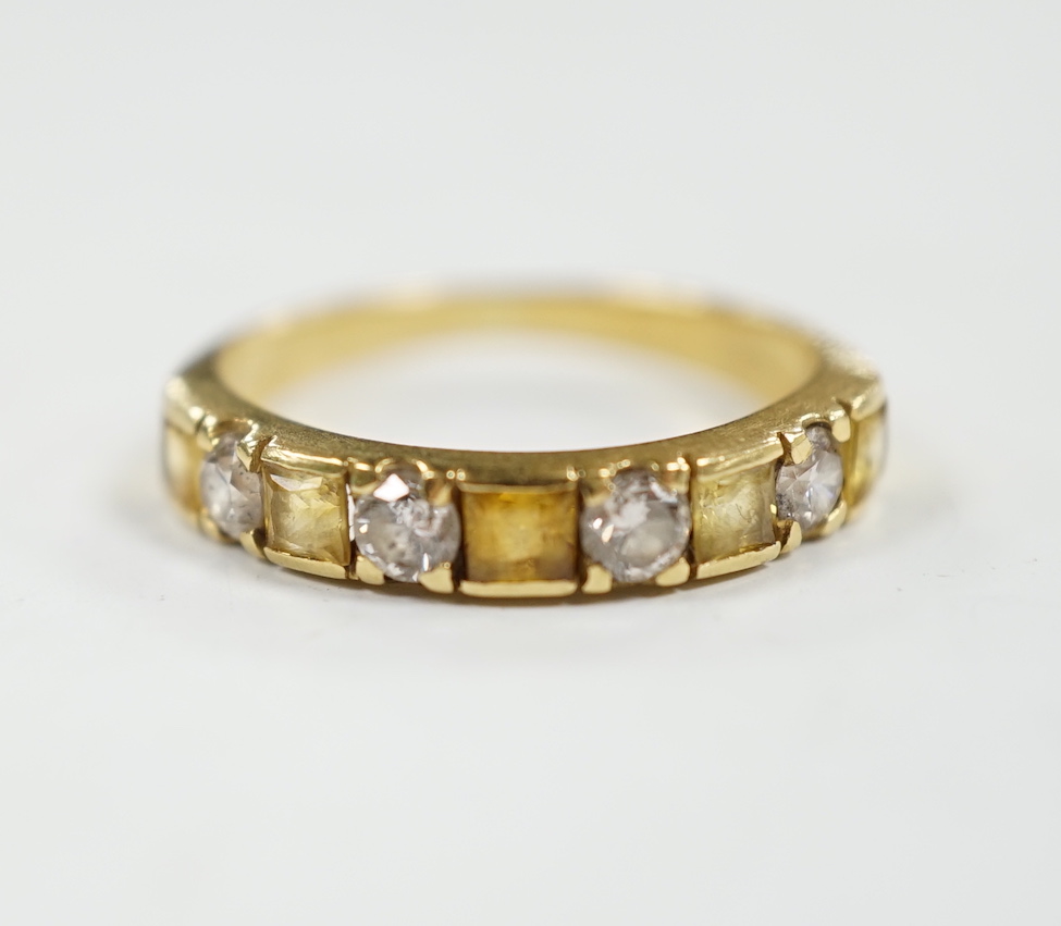 A yellow metal, five stone square cut yellow sapphire and four stone round cut diamond set half hoop ring, size N, gross weight 3.2 grams.